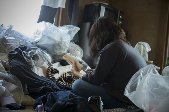 Person sitting in garbage