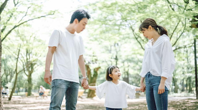 Parents holding child's hand