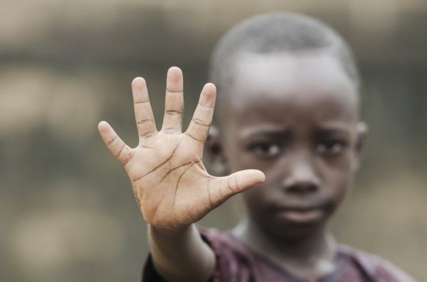 Boy holding up hand to say stop