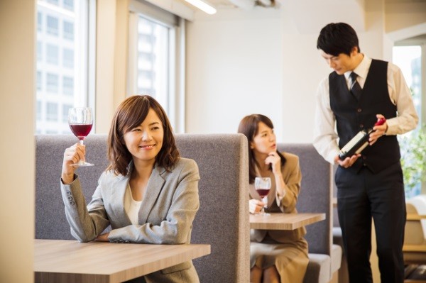 Two women enjoying wine alone