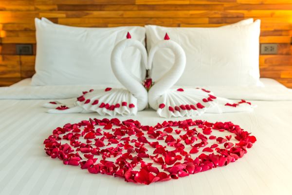Heart shape on hotel room bed