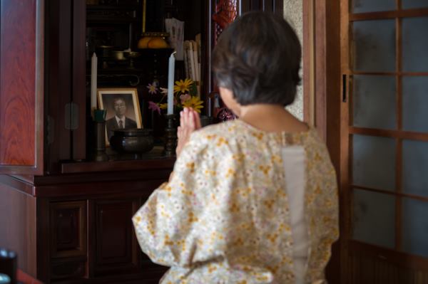 Woman at Buddhist altar