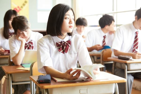 Girl at school looking out window