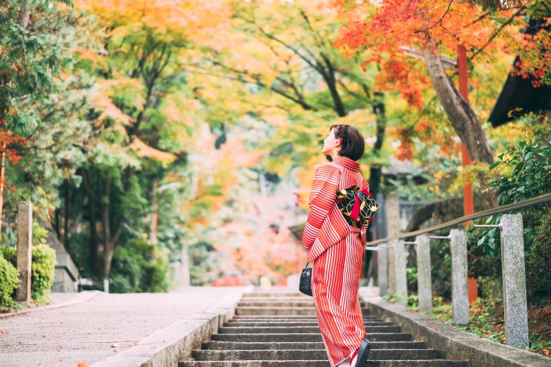 Woman in yutaka looking at leaves