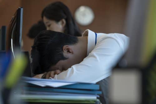 Man with head on desk