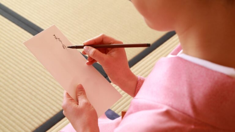 Woman writing a haiku on paper