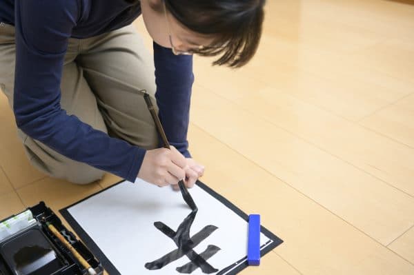 Woman drawing kanji