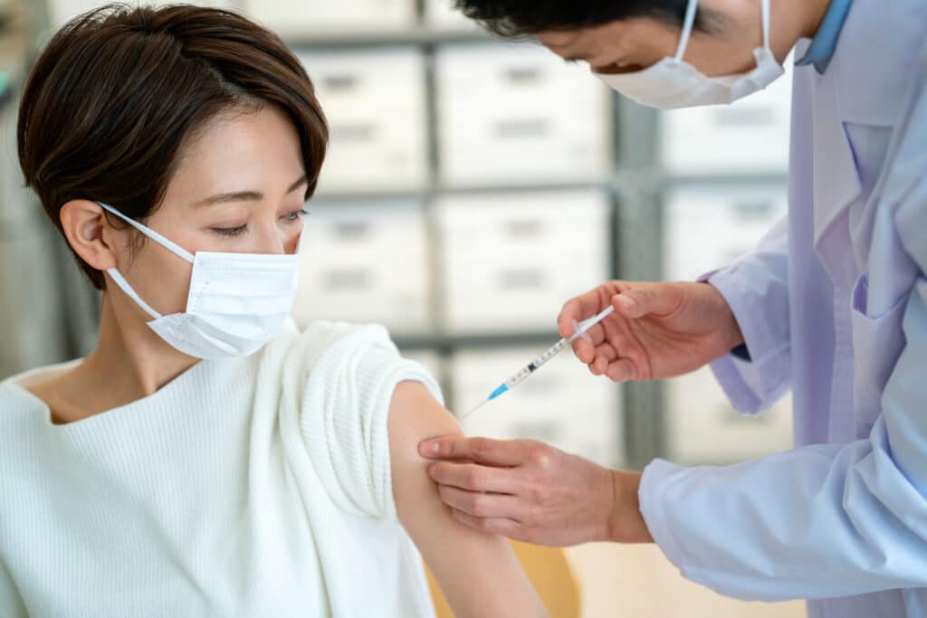 A Japanese national receives a shot. Foreigners in Japan watched on as friends in other countries received vaccines months before they became widely available in Japan.