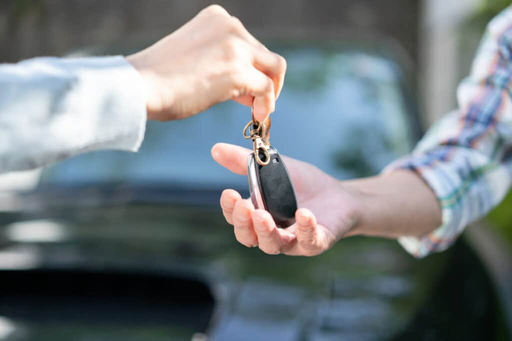 Elderly drivers exchanging keys