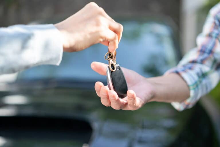 Elderly drivers exchanging keys
