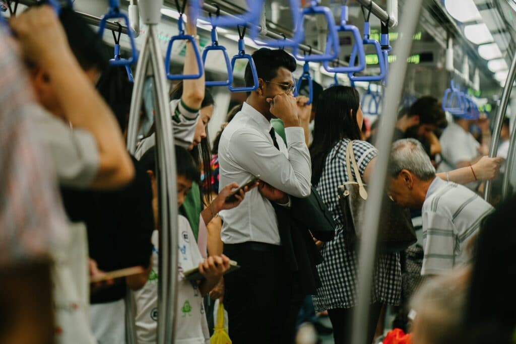 man stands inside a crowded train (michi no eki let you avoid that!)