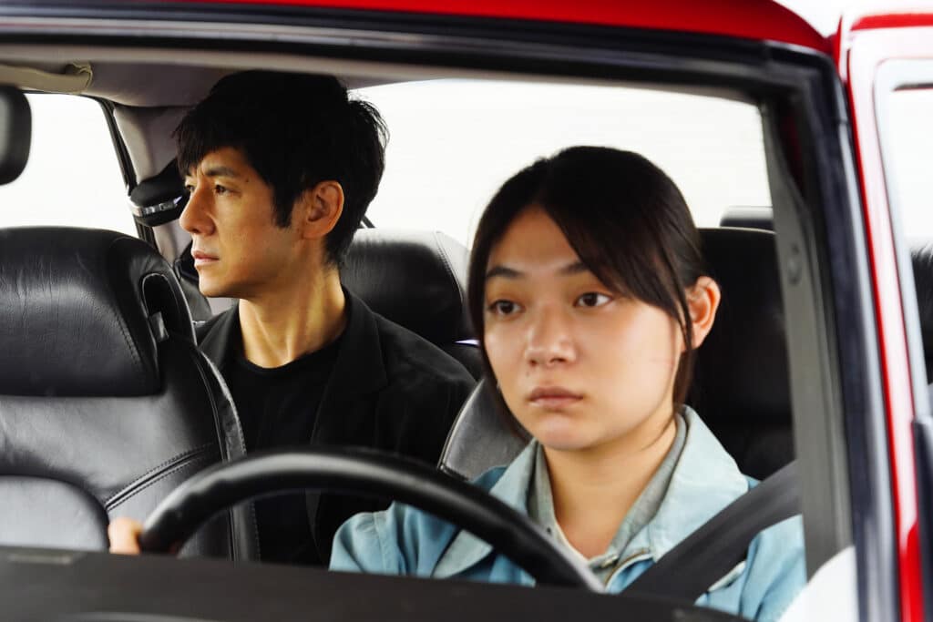 Nishijiima Hidetoshi, with Miura Toko in the driver's seat in Drive My Car.
