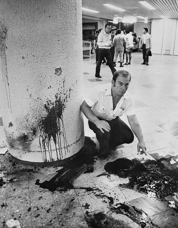An Israeli soldier looks at blood spilled during the Lod Airport Massacre, which Shigenobu Fusako is believed to have masterminded.