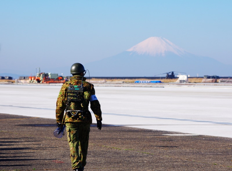 Self Defense Force (SDF) soldier in shot with Mt. Fuji