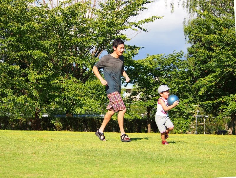 Father and son playing in park