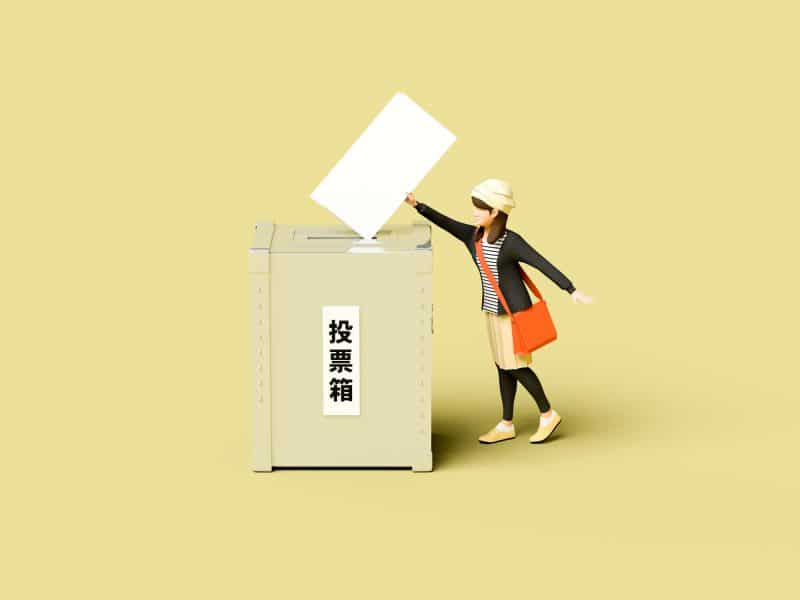 A figure of a woman casting a ballot