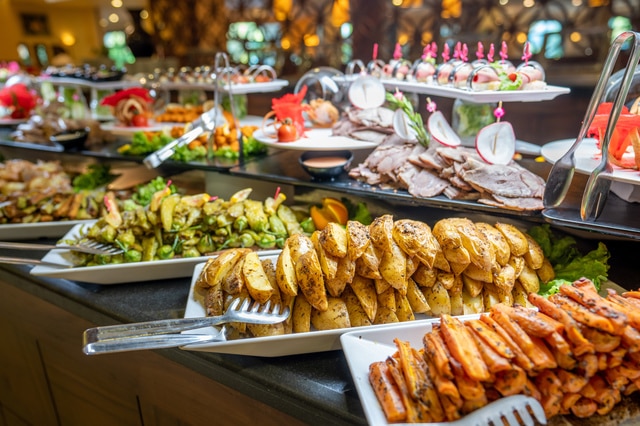 Close up of foods with plates in buffet of restaurant