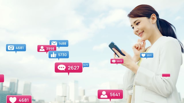 Social networking services (woman holding phone looking at her socials)