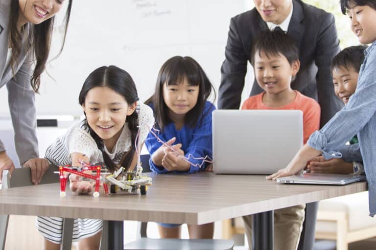 Girl playing with a computer-controlled toy car
