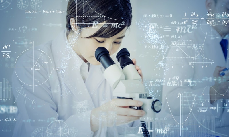 Woman looking into microscope