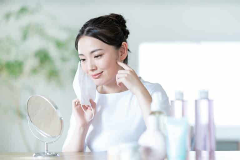Woman removing her mask