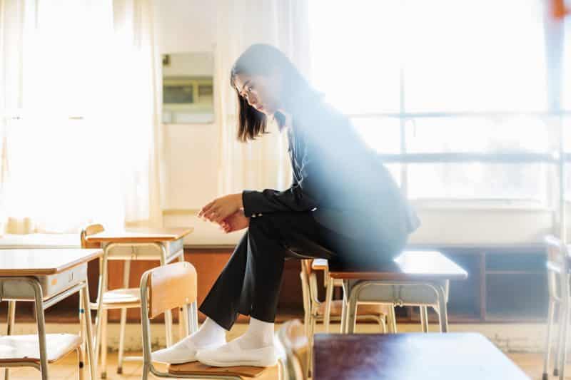 Woman sitting on desk - gender equality, Miss Contests in Japan