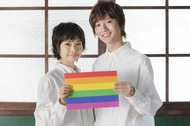 Couple holding LGBGTQ flag