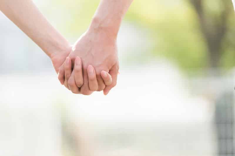 Two people holding hands (gaijin hunter article)