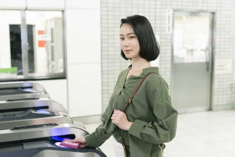 Woman entering subway gate with a tap payment