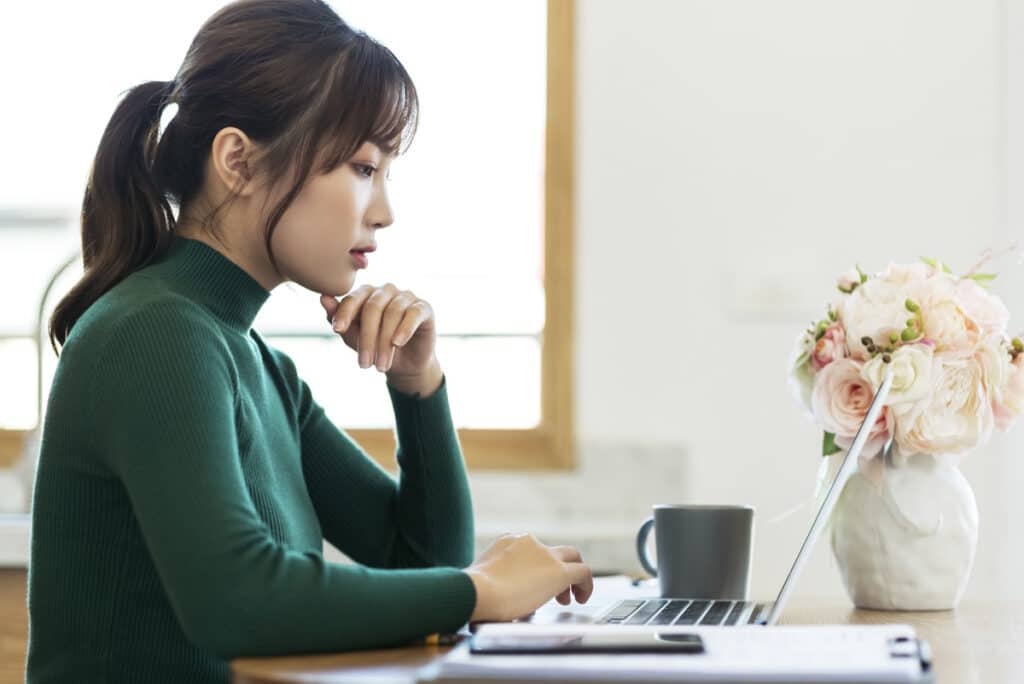 Digital nomads - Japan visa: woman working at home on her laptop