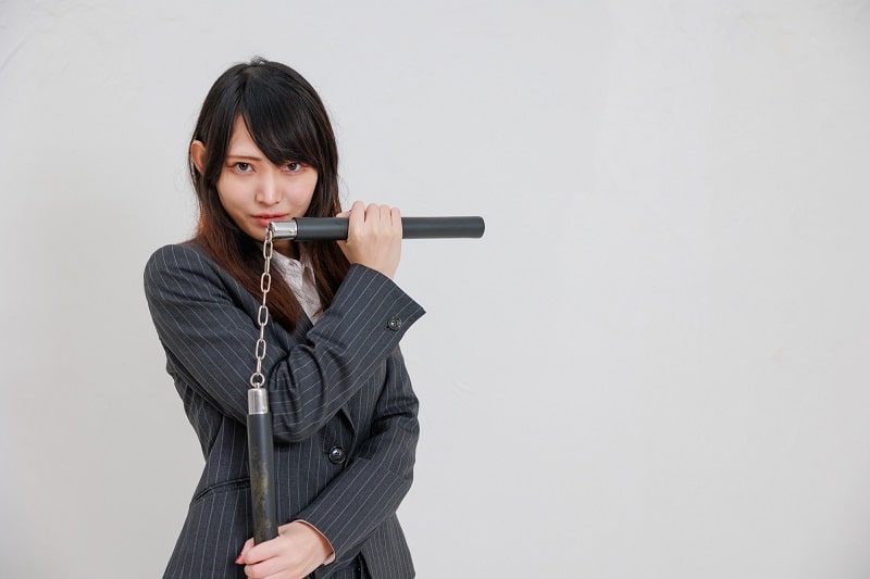 Woman holding nunchaku (nunchucks)