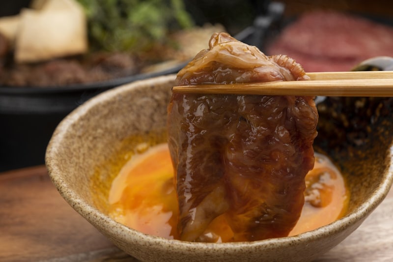 Sukiyaki meat dipped in raw egg - raw eggs and Japan