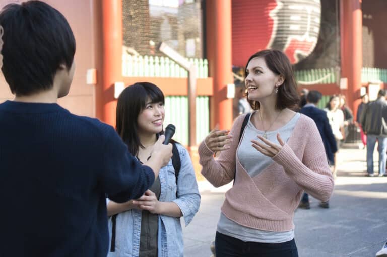 Woman talking with reporters in Asakusa
