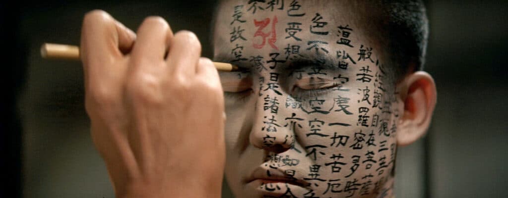 A Buddhist acolyte has Japanese and Sanskrit characters drawn onto his face via ink brush in the film Kwaidan.