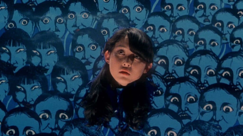 The head of a teenaged girl with long hair floats in front of a illustrated blue background of tortured souls in the film House.