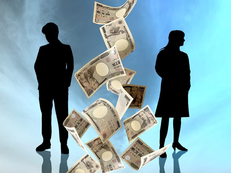 Man and woman in silhouette with a flurry of yen falling between them