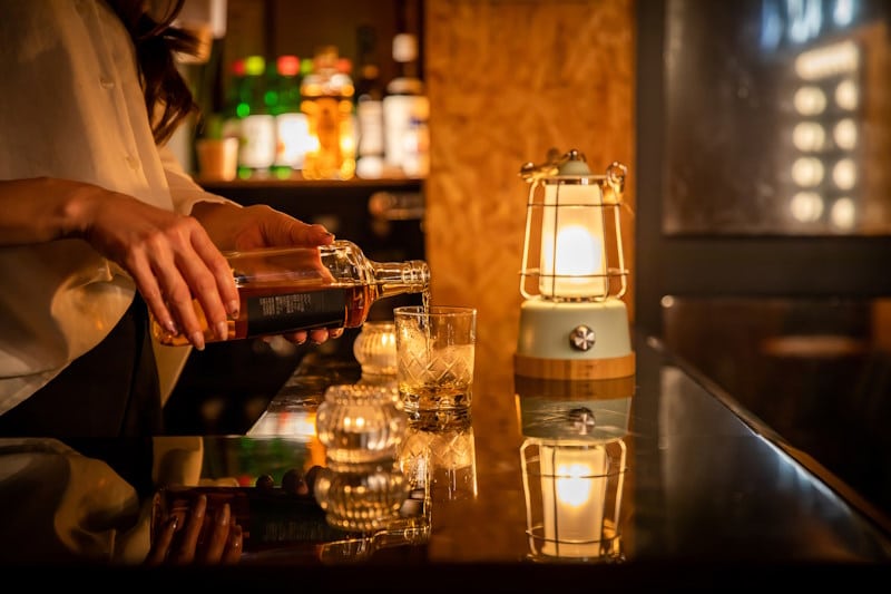 Bartender pouring alcohol at a bar 