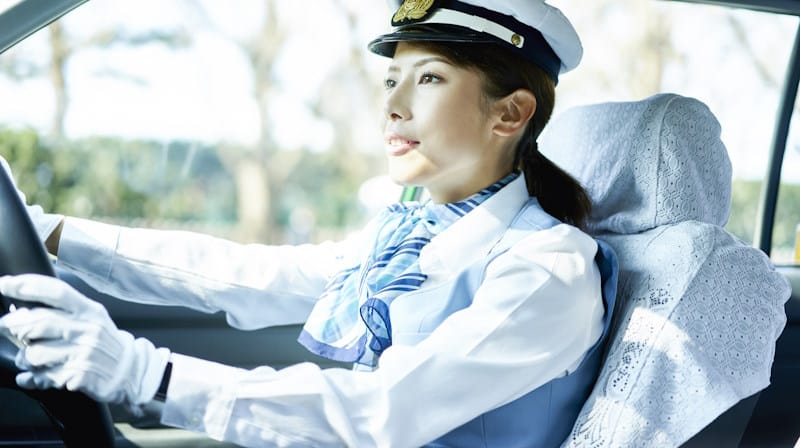 Woman driving a taxi. Don't worry, she's licensed. We think...