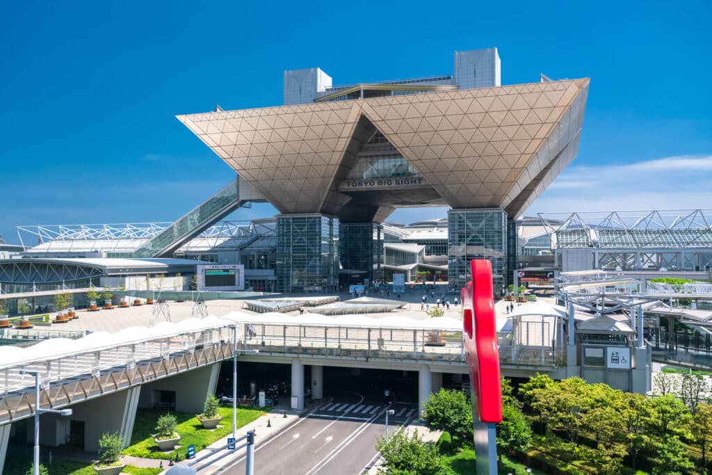 The Tokyo Big Sight, with inverted architectural pyramid shapes on large stalks hovering over the main convention space.