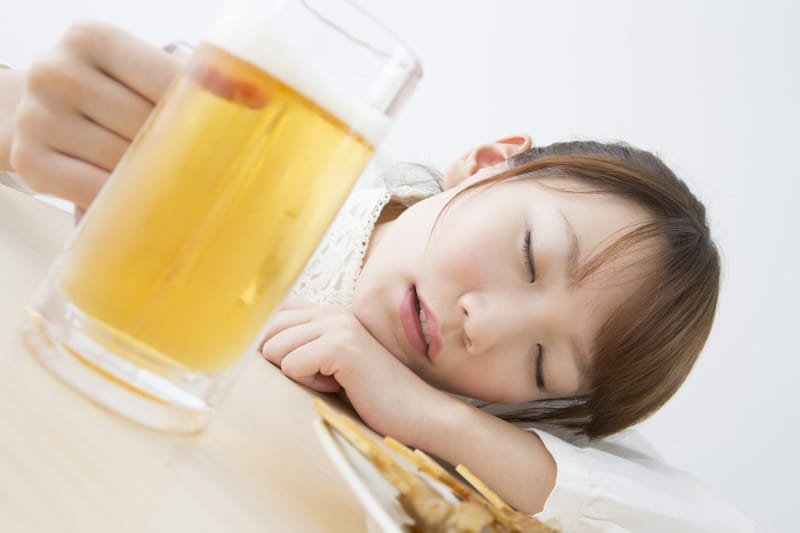 Woman nearly asleep after drinking beer