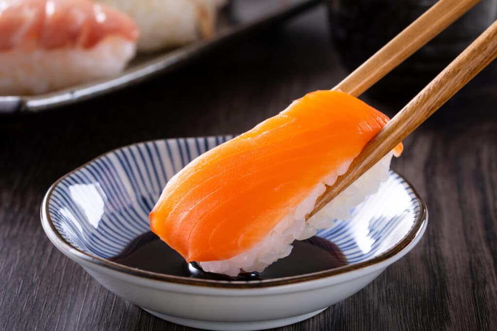 Dipping sushi in soy sauce