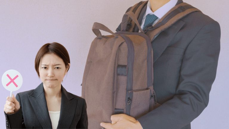Passenger holding backpack in front on crowded Japanese train