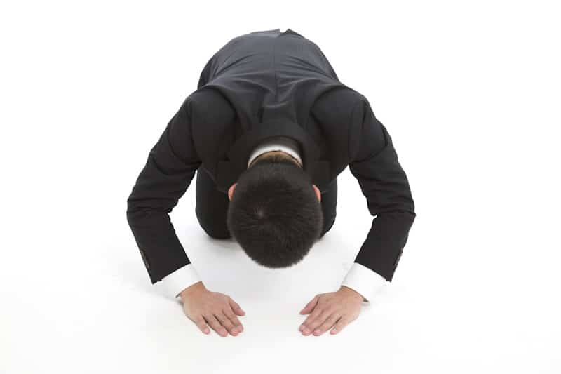 Man doing deep dogeza bow on the floor