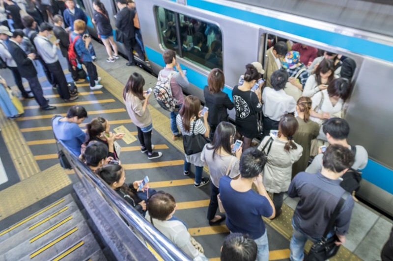 People boarding a crowded subway train