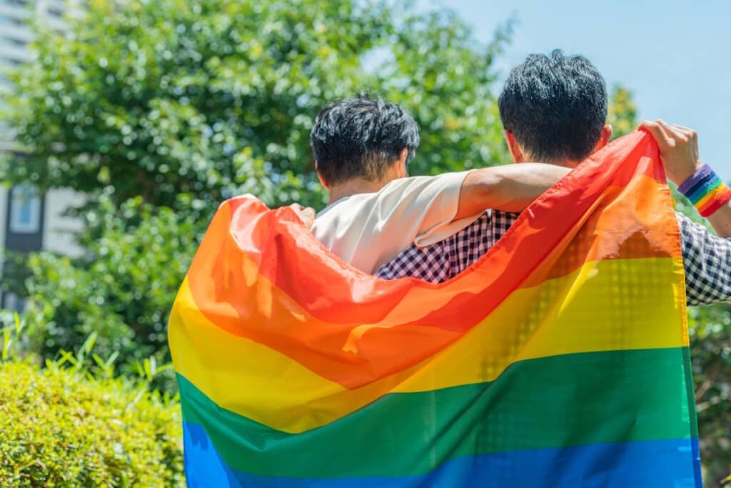 Same sex couple with LGBTQ flag