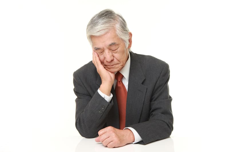 Older man in a suit sleeping