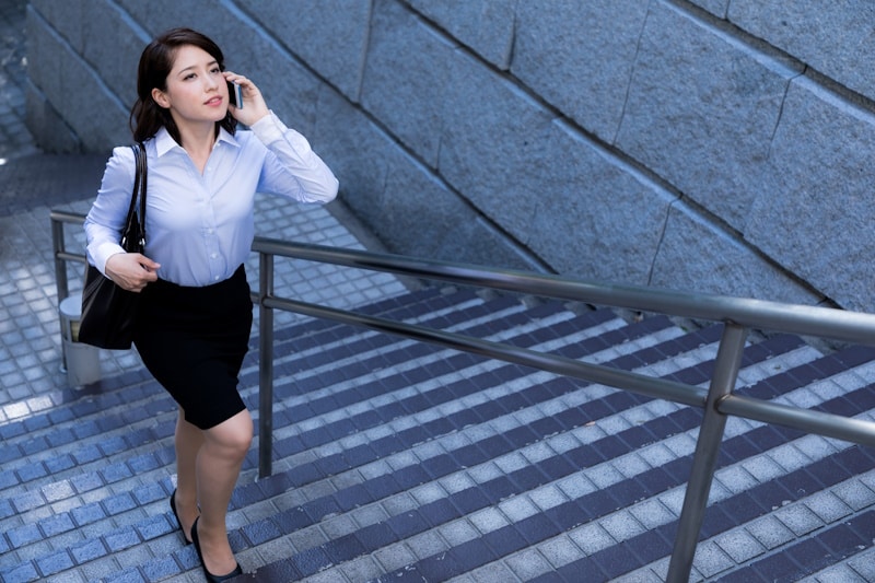 Woman walking up stairs out of train station