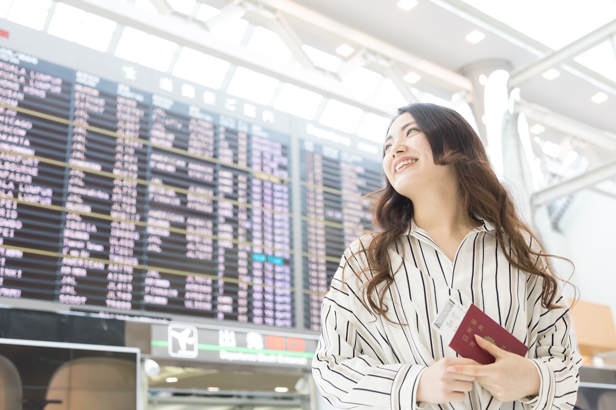 Japanese woman holding passport at airport