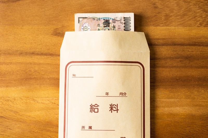 Envelope that reads "salary" with yen peaking out of the top