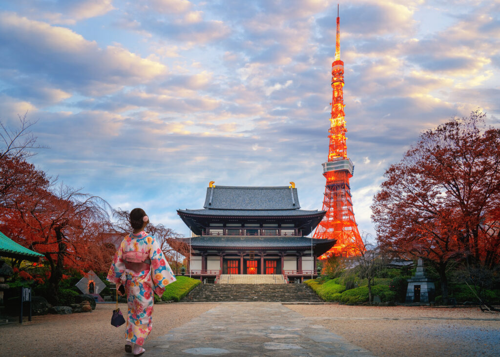 apanese women in kimono dress walk in Zojoji temple in Tokyo city with Tokyo tower background, Japan, Asia.